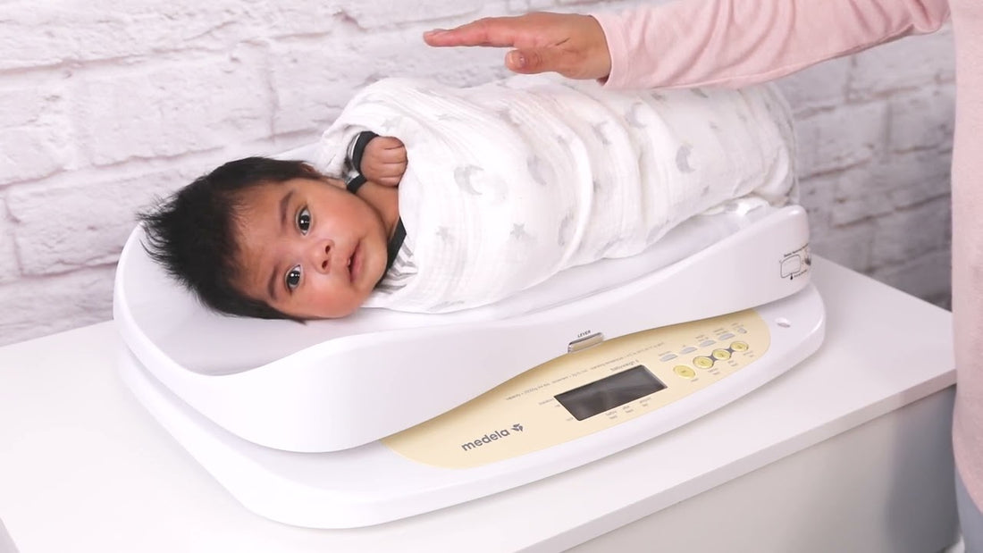 Weighing a baby on a Medela BabyWeigh II scale, to calculate milk intake of a breastfed baby